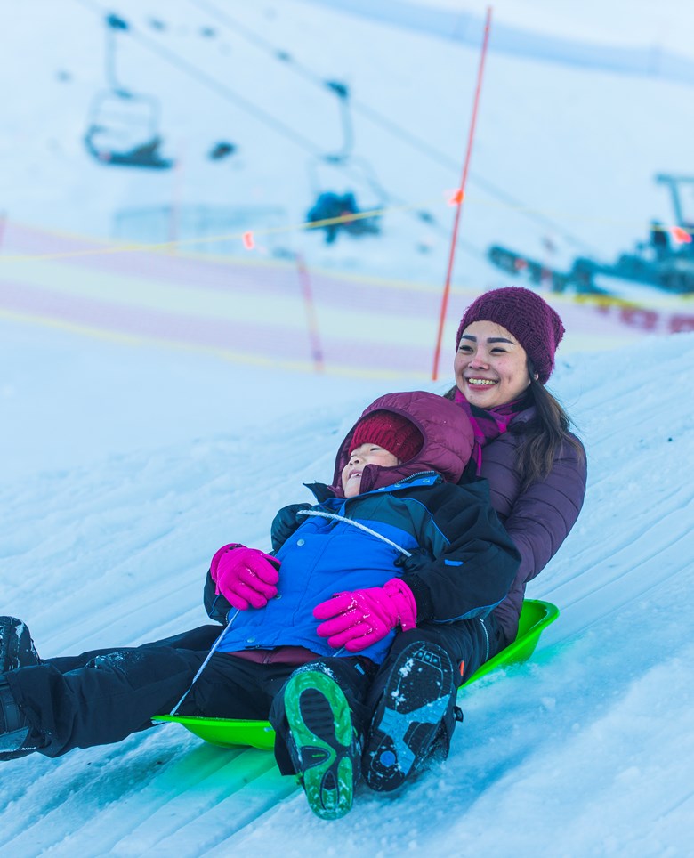 Mother and son sledding