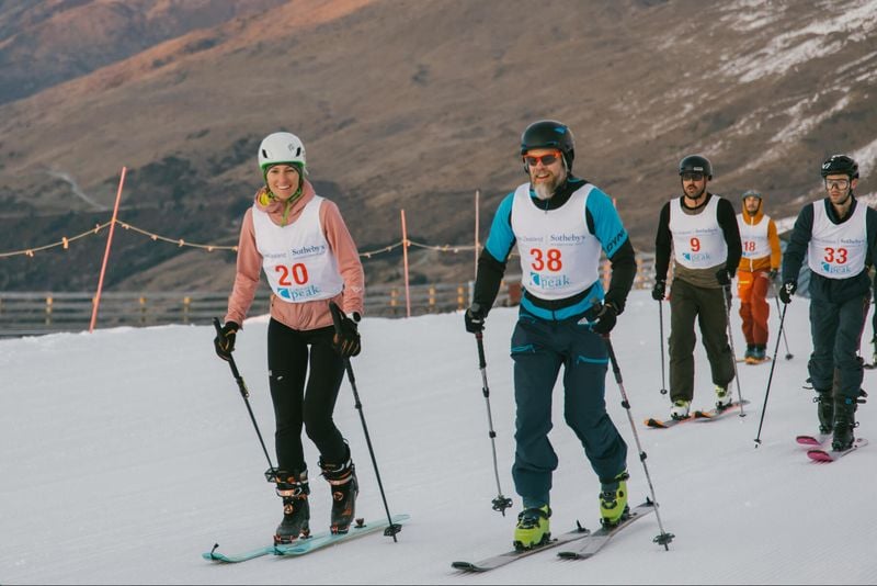 Skiers skinning up Coronet Peak.