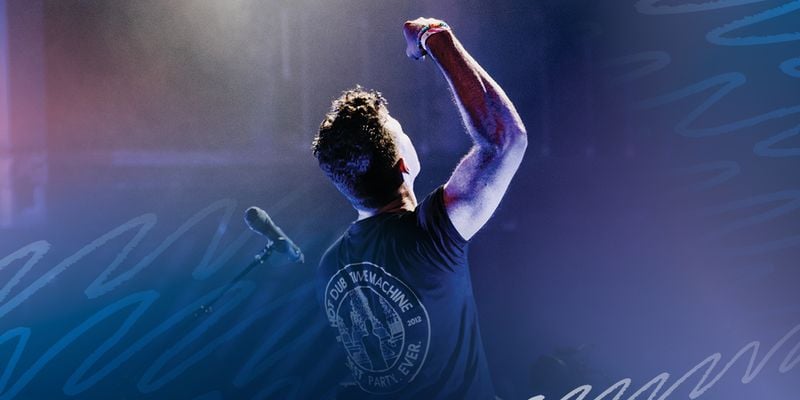DJ with arm raised in the air.