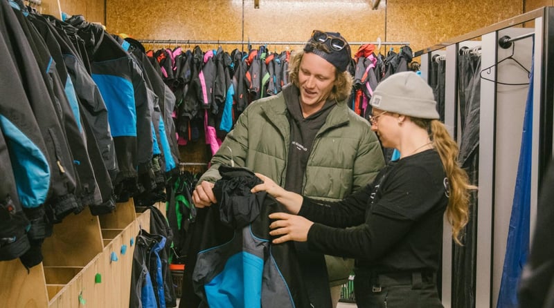 People selecting ski jackets in a rental shop at Mt Hutt