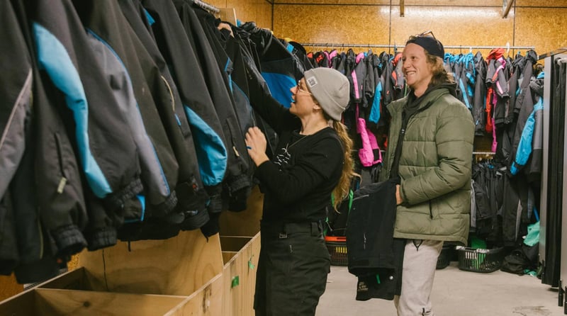 People selecting ski jackets in a rental shop at Mt Hutt